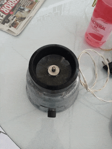 a bottle of electroral next to a blender on a table