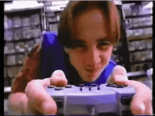 a young man is playing a video game with a controller in a store .