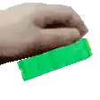 a hand is holding a green candy bar in its hand .