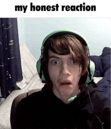 a young man wearing green headphones making a funny face