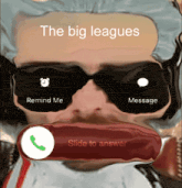 a man wearing sunglasses is talking on a phone with the big leagues written above him