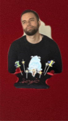 a man with a beard wears a black sweater with a sheep on it