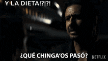 a man in a black shirt is talking to someone in a dark room and says `` y la dieta ! ''