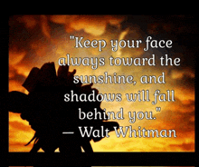 a quote by walt whitman with a flower in the background