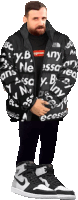 a man wearing a black jacket with supreme on it