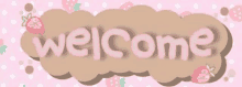 the word welcome is written on a pink background with strawberries .