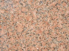 a close up of a granite surface with a pink and grey color