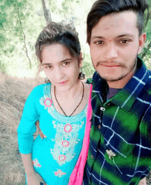 a man and a woman posing for a picture in a field