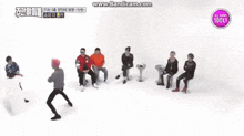 a group of young men are dancing in front of a sign that says all about idol