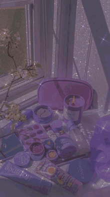 a table with purple cosmetics and a candle with florence written on it