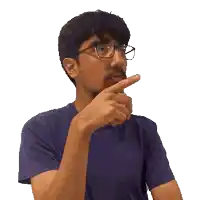 a man with glasses and a beard is pointing his finger
