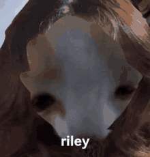 a close up of a person 's face with the name riley written on the bottom