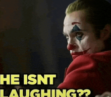 a man in a clown costume with the words he isnt laughing on the bottom
