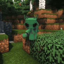 a green monster in a minecraft game is standing on a green block