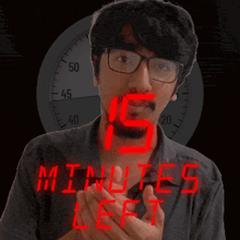 a man in front of a clock that says 15 minutes left in red