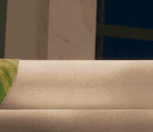 a person laying on a bed with a green blanket