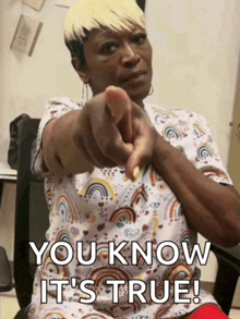 a woman pointing at the camera with the words " you know it 's true " on the bottom