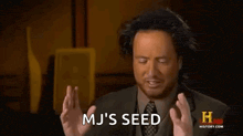 a man in a suit and tie is making a funny face and saying mj 's seed .