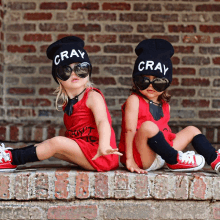 two little girls wearing hats that say cray on them