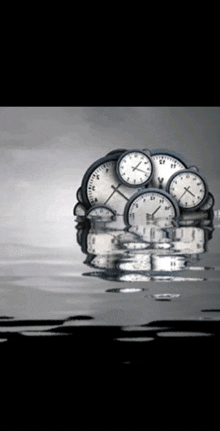 a bunch of clocks are floating in the water and one of them has the number 11 on it