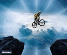 a man is riding a bicycle over a cliff in the sky .