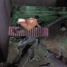 a man in a cape is surrounded by alligators