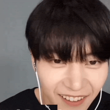 a close up of a man wearing headphones and smiling .