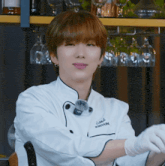 a young man in a chef 's uniform with the name kihyun written on it