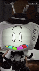 a stuffed toy that looks like a tv with a colorful face and the number 00 on it
