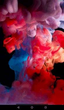 a phone screen shows a colorful smoke coming out of a bottle