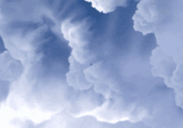 a small plane is flying through the clouds in the blue sky