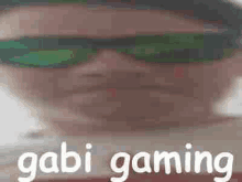 a close up of a person wearing sunglasses with the words gabi gaming written next to them .