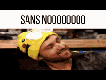 a man wearing a pikachu hat with the words sans no000000 on the bottom