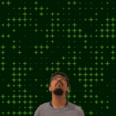 a man with glasses and a beard is looking up at the number 12