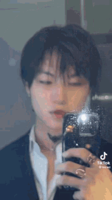 a person is taking a picture of themselves in a mirror with their phone .