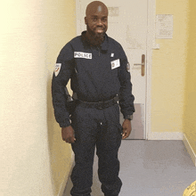 a man in a police uniform stands in front of a white door