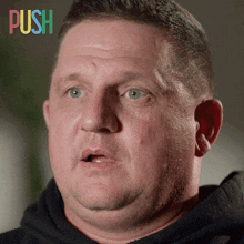 a close up of a man 's face with the word push in the corner