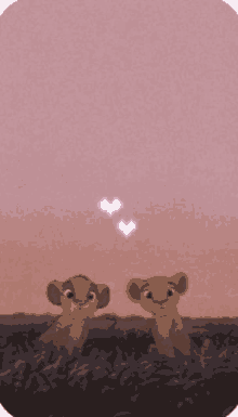 two lion cubs are sitting in a field with hearts in the sky above them