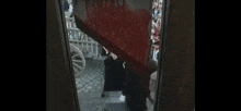 a man is walking down a set of stairs with blood coming out of a window .