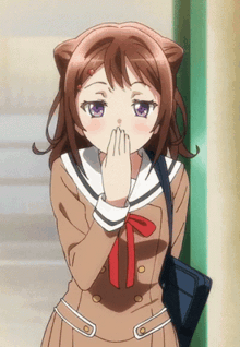 a girl with cat ears on her head covering her mouth with her hands