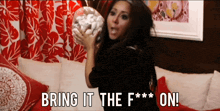 a woman holding a donut with the words bring it the f *** on