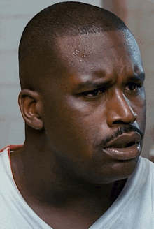 a close up of a man 's face with sweat on his face