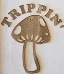 a close up of a mushroom with the words `` trippin '' written on it .