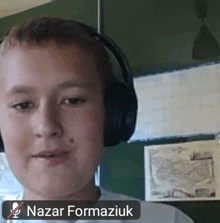 a young boy wearing headphones with nazar formaziuk written next to him