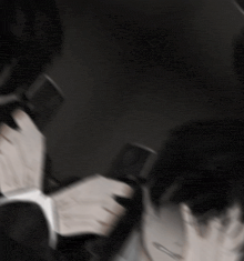 a man in a suit and tie is holding a gun in his hands