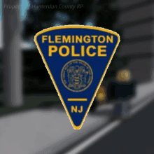 a blue and yellow flemington police patch with a seal on it