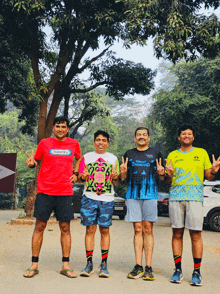 four men are posing for a picture and one of them has a shirt that says 2024