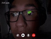 a man wearing glasses and headphones is on a video call with ivcam in the background