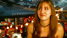 a woman stands in front of a banner that says " hallownest "