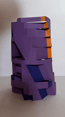 a stack of purple and orange pieces of paper against a white background